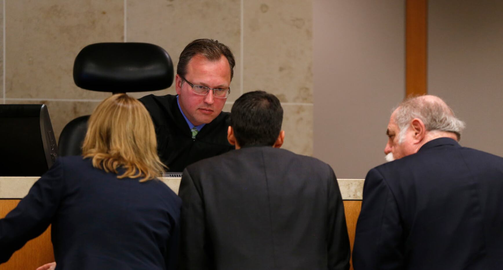 Judge Scott Becker (top) talks with prosecutors Cynthia Walker (left) and Wes Wynne (center)...