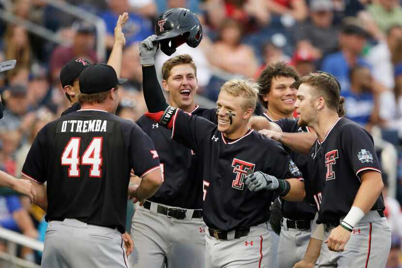 Texas Tech's Brian Klein, third from right, celebrates his solo home run against Florida...