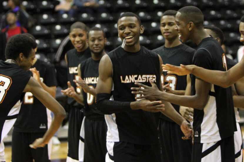 Lancaster guard Kaelon Wilson (4) was all smiles as he received congratulations from...