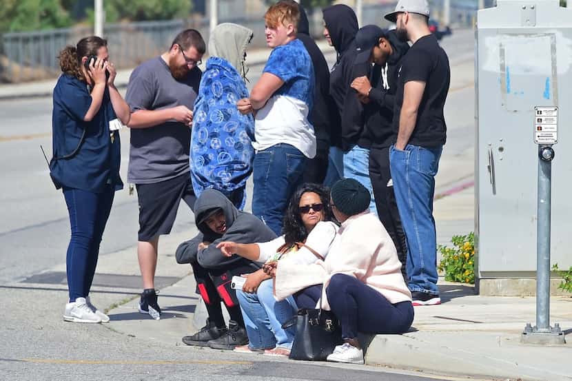 People wait at an intersection May 11, 2018 following reports of shooting at Highland High...
