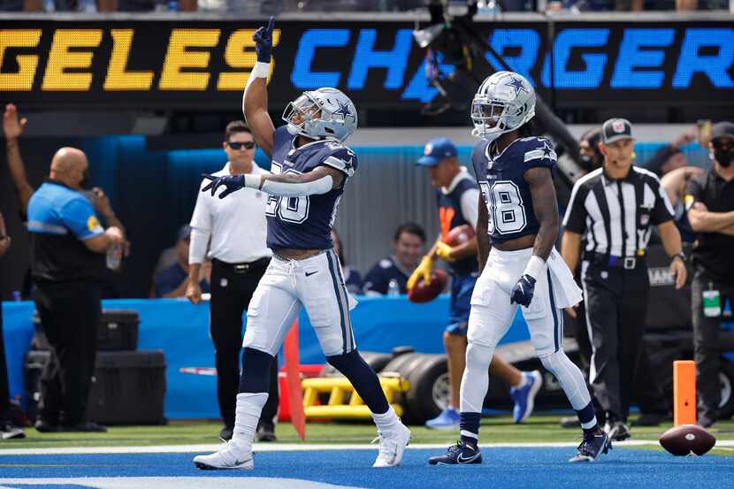 Dallas Cowboys running back Tony Pollard (20) celebrates his first quarter touchdown against...