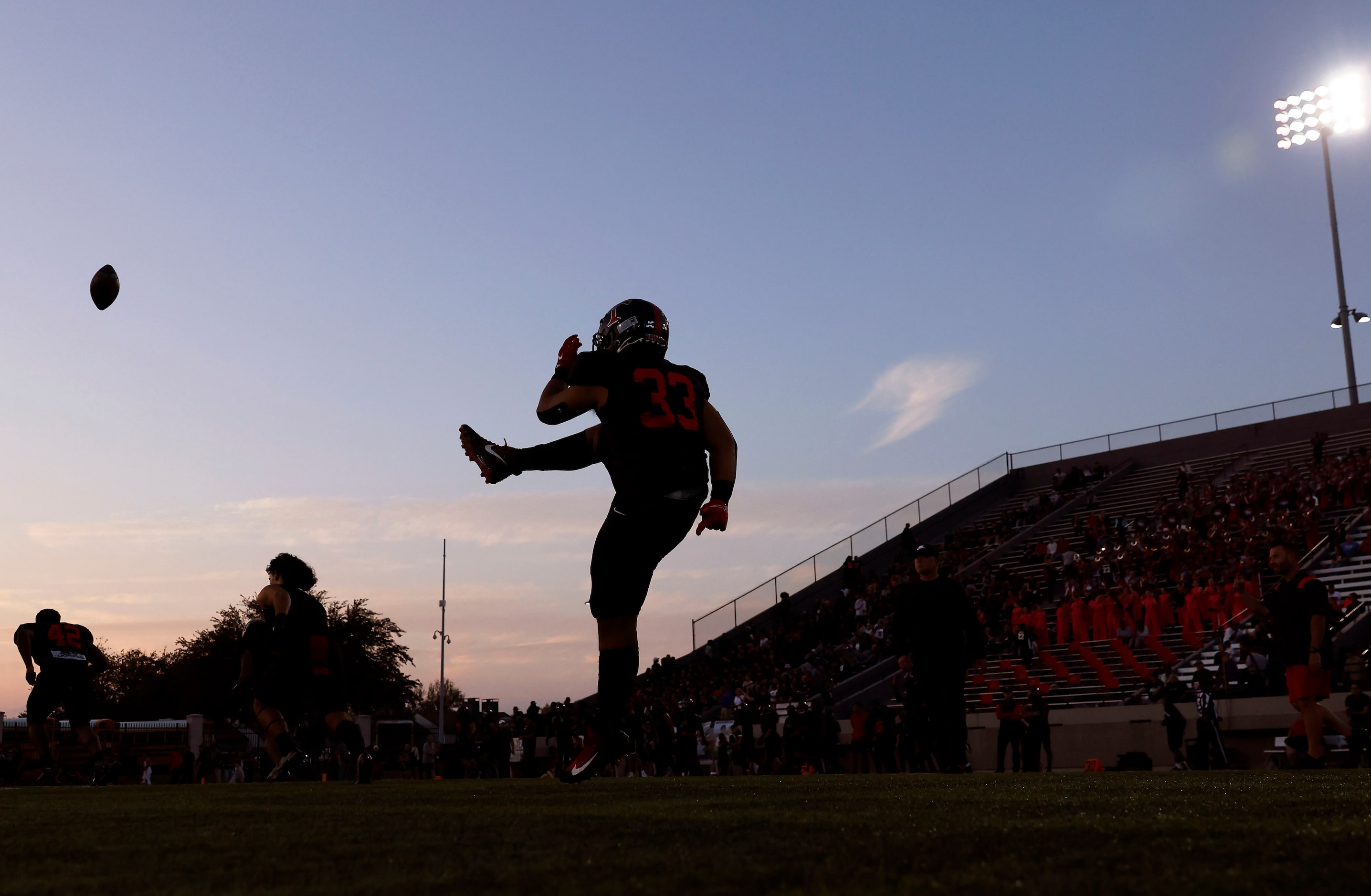 Euless Trinity punter Buddy Leota (33) practices before  facing Hurst L.D. Bell at...