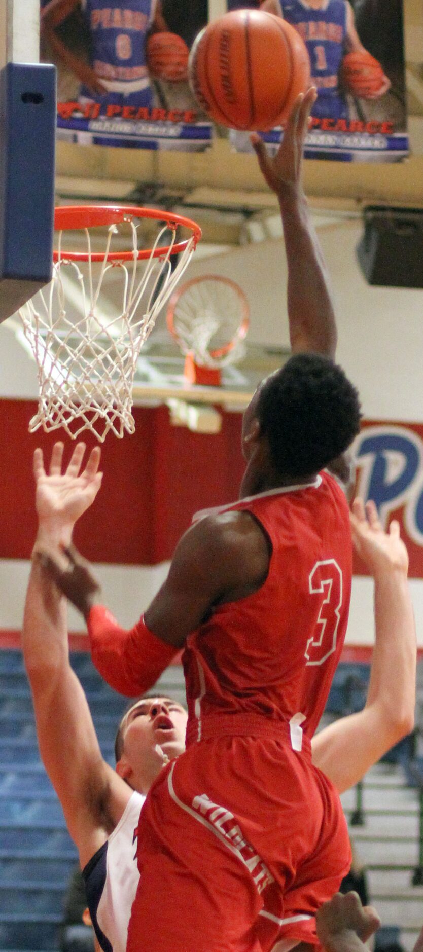 Woodrow Wilson's Hassan Thomas (3) drives hard to the basket and scores over the defense of...