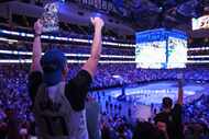 Dallas Mavericks fans cheer following a point during a watch party of Game 1 of the NBA...