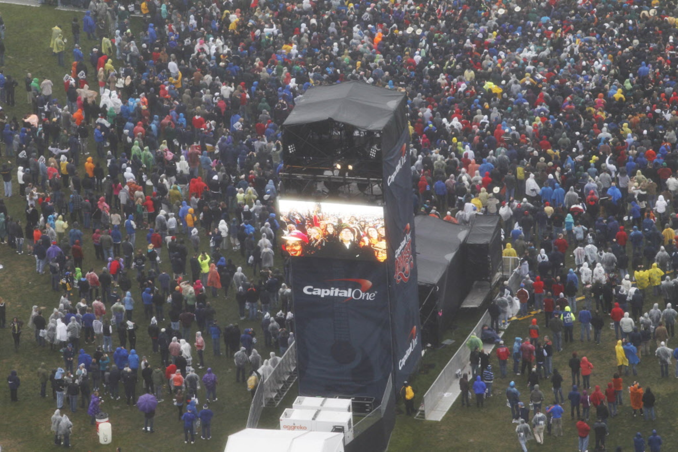 The crowd responds to the band, Fun, as they perform in the rain and cold weather Sunday,...