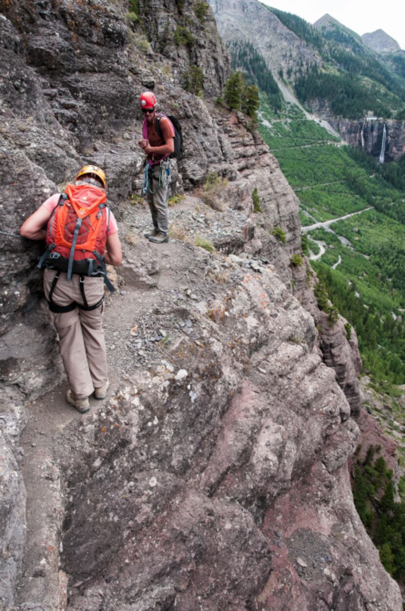 Guide Joe Eppler watches as Dianne Leeth unclips from a narrow section of Telluride's Via...