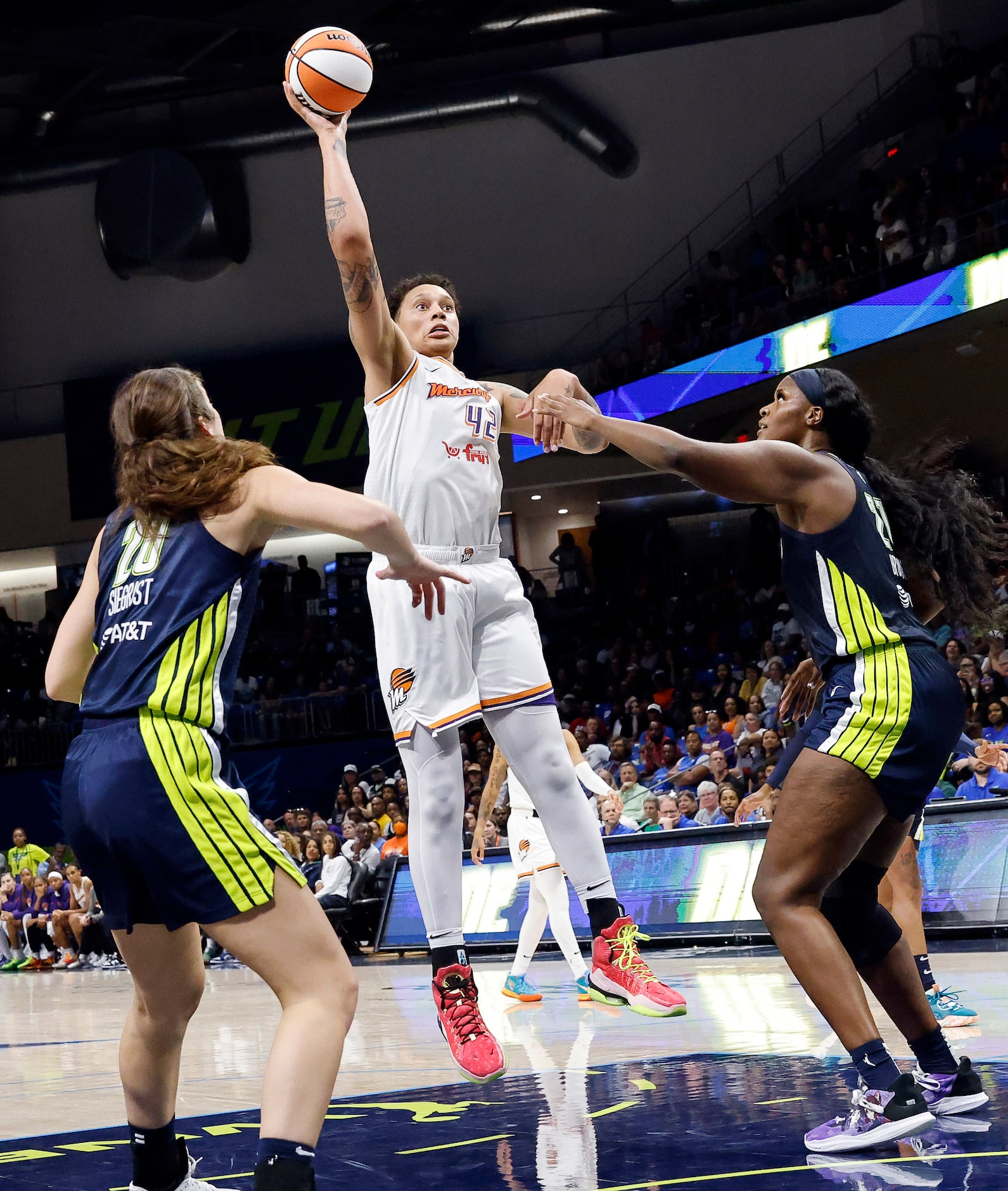 Phoenix Mercury center Brittney Griner (42) tunes and puts up a one-handed shot over Dallas...