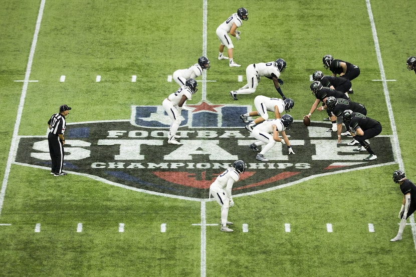 The Frisco Lone Star defense lines up against the Cedar Park offense during the Class 5A...