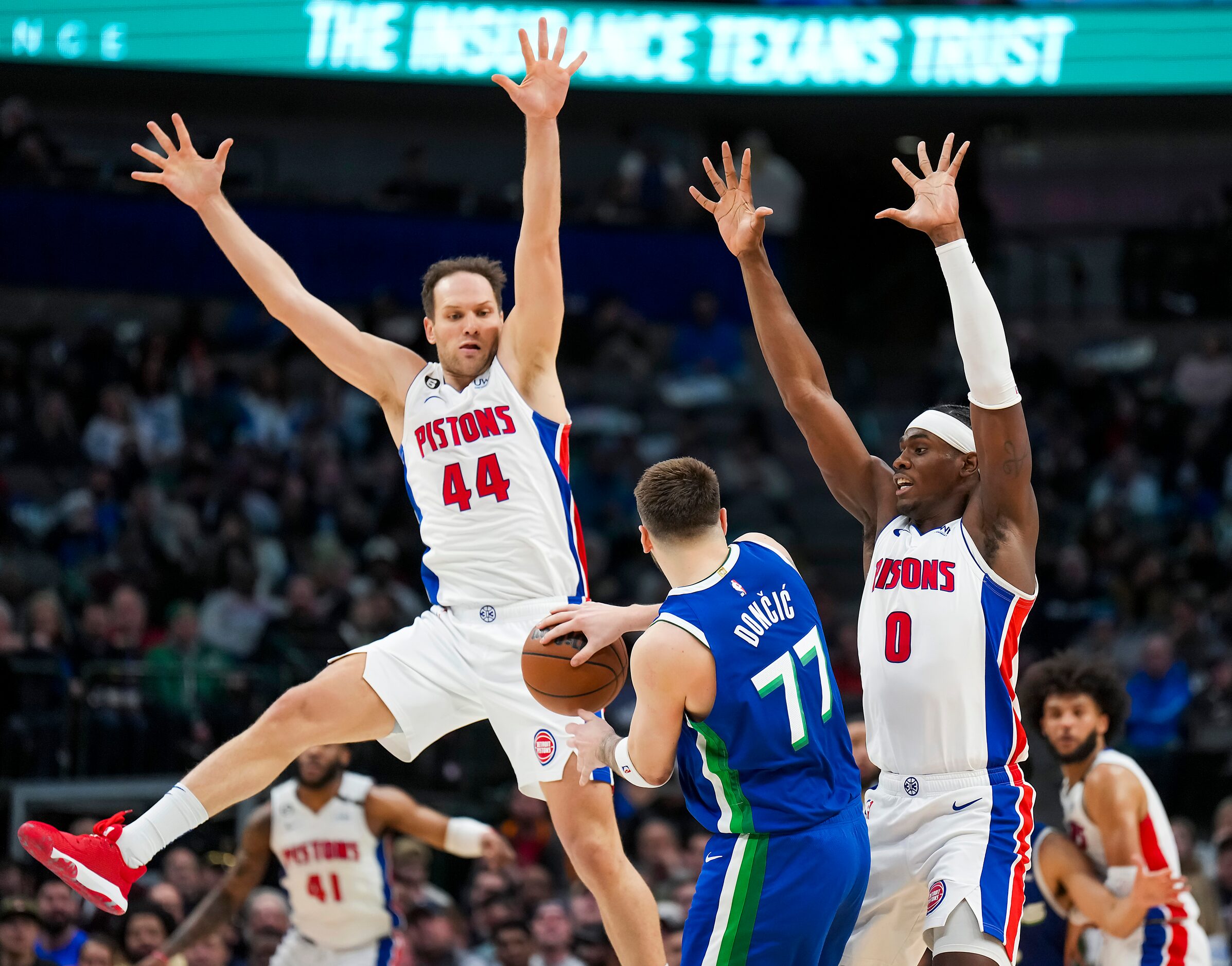 Dallas Mavericks guard Luka Doncic (77) passes the ball as Detroit Pistons forward Bojan...