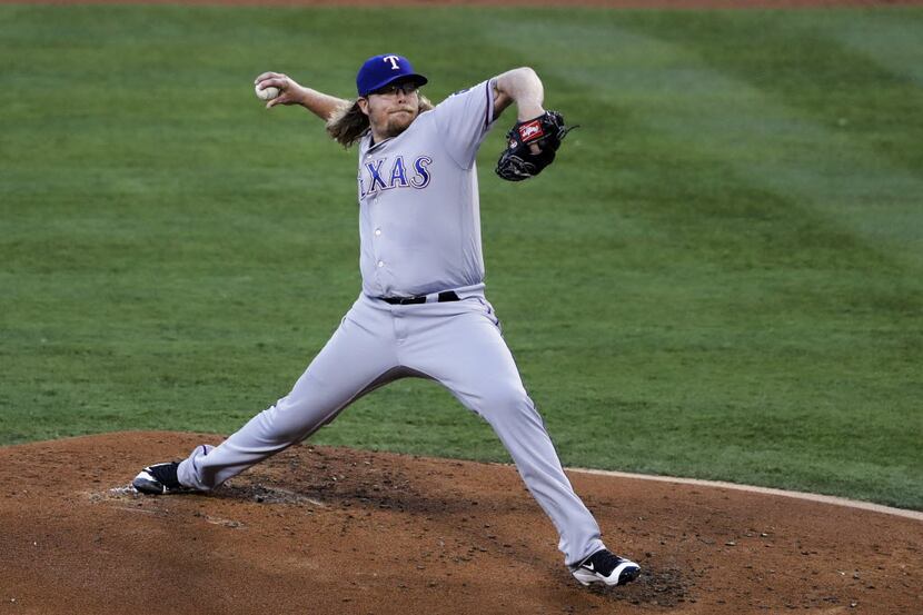 Texas Rangers starting pitcher A.J. Griffin works against a Los Angeles Angels batter during...