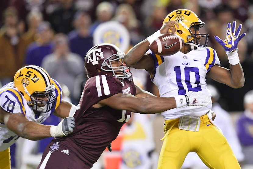 Texas A&M defensive lineman Myles Garrett (15) tackles LSU quarterback Anthony Jennings (10)...