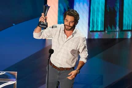 Thomas Rhett accepts the entertainer of the year award in a tie with Carrie Underwood.