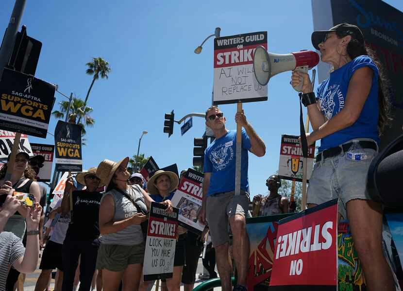 Justine Bateman, right, speaks outside Netflix during a Writers Guild rally as a strike by...