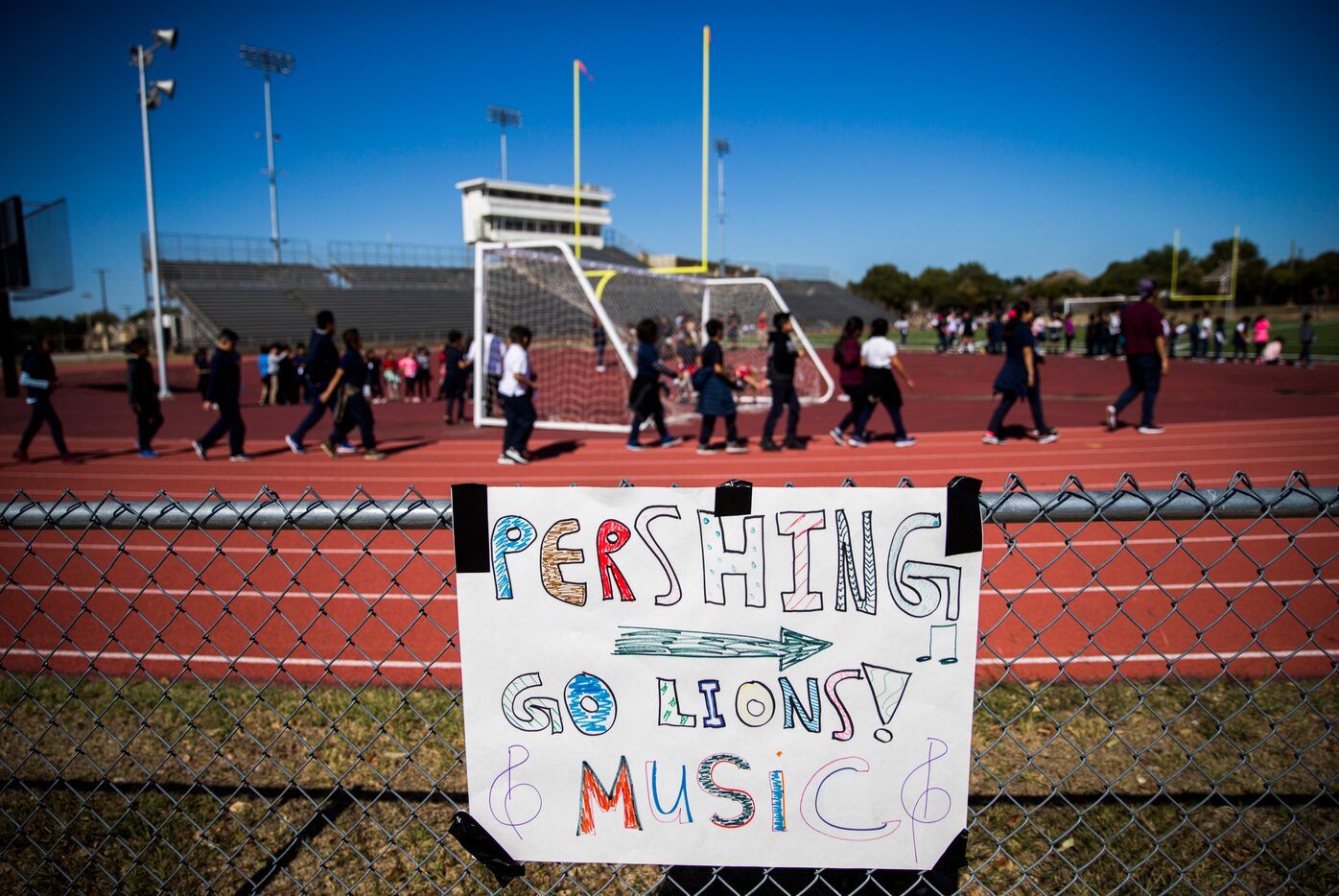 Burnet, Cigarroa and Pershing elementary school students play on the track and football...