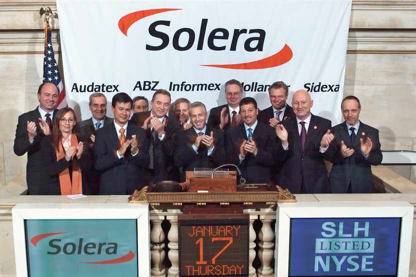 CEO Tony Aquila, center, and other officials celebrate Solera Holdings Inc. first day of...