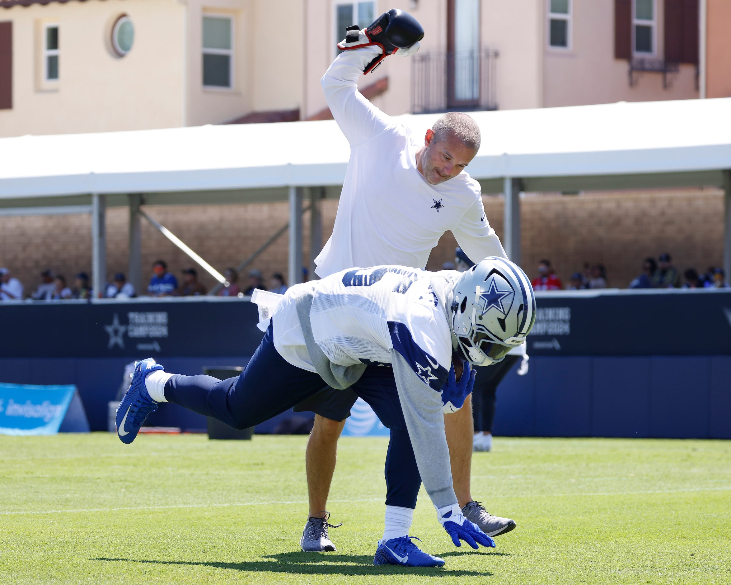 Dallas Cowboys running back Ezekiel Elliott (15) runs a drill where he continually takes...