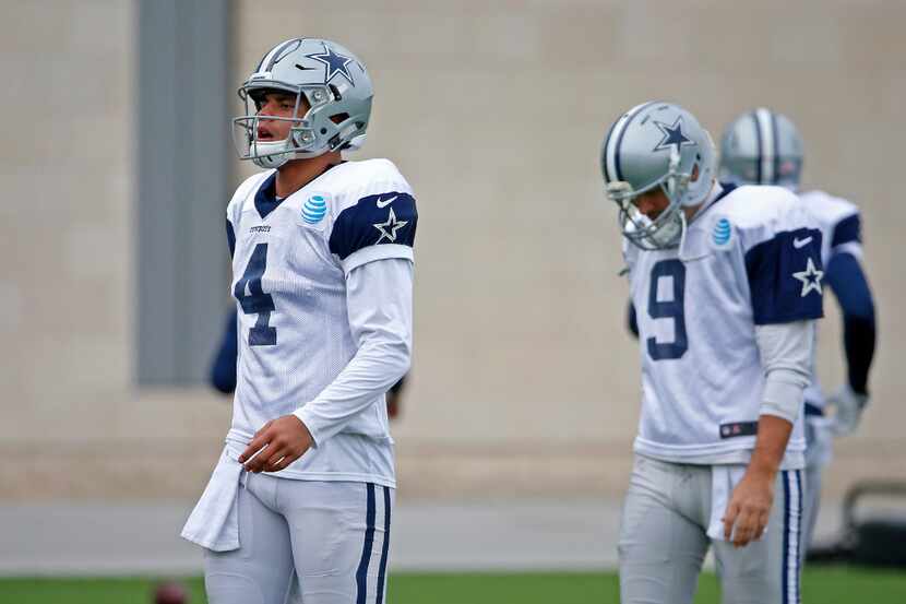 Dallas Cowboys quarterbacks Dak Prescott (4) and Tony Romo walk on the field during practice...
