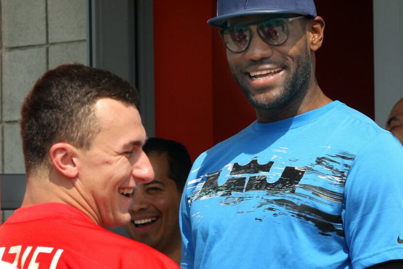 Cleveland Cavaliers' LeBron James, right, talks with Cleveland Brown quarterback Johnny...
