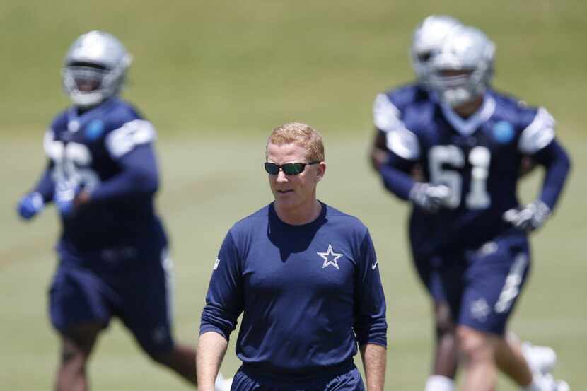 Dallas Cowboys head coach Jason Garrett walks down the sideline during rookie minicamp at...