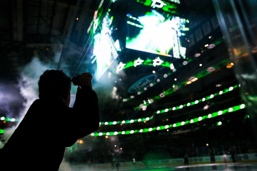Aiden Gann, 8, watches as the Dallas Stars take the ice before their game against the...