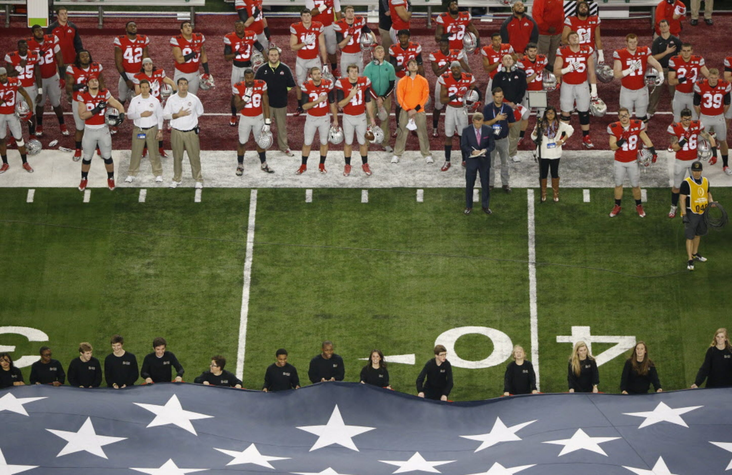 Ohio State Buckeyes players listening while Lady Antebellum signs the United States National...