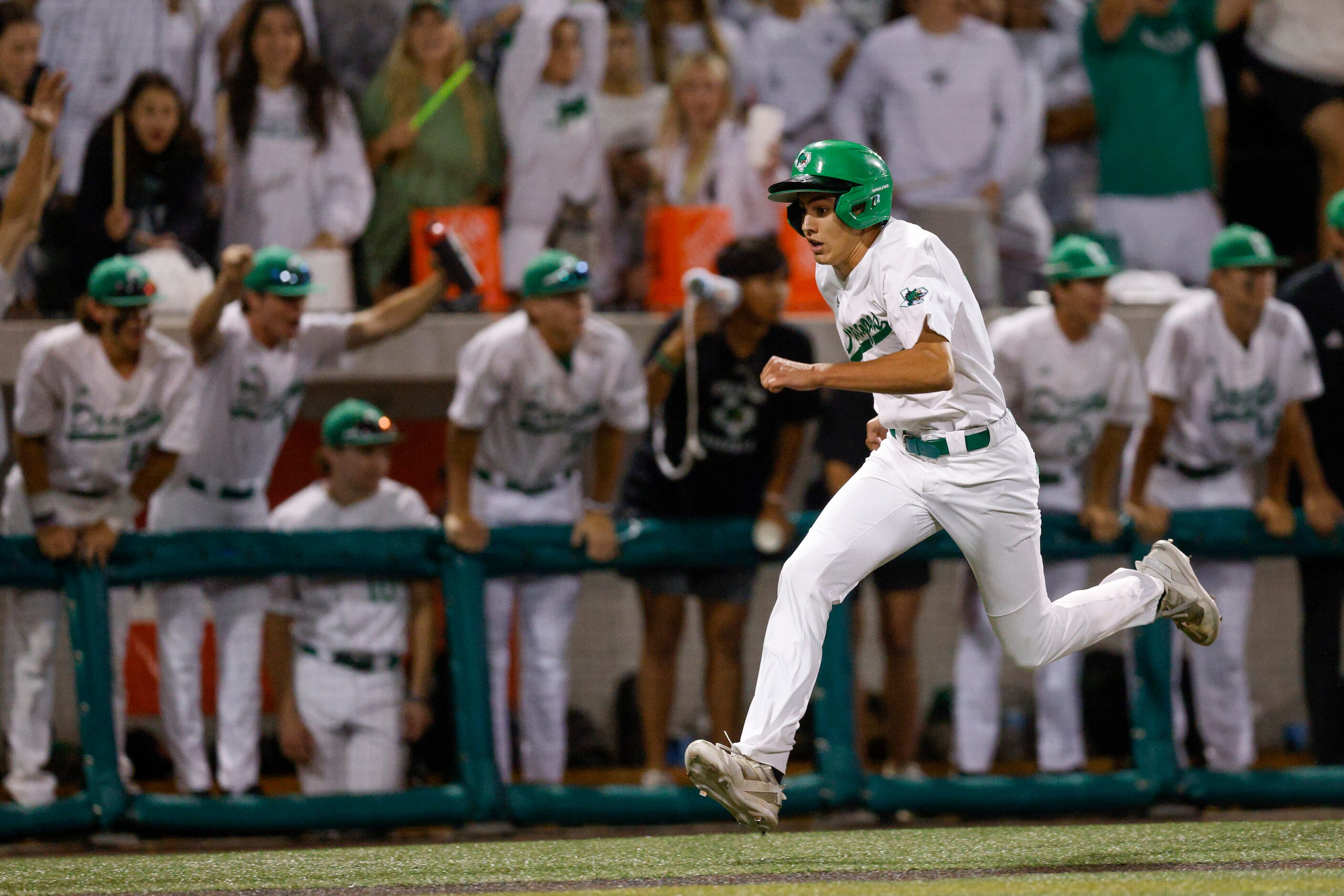 Southlake Carroll pinch runner Colin Robson (30) scores a run during the fifth inning of...