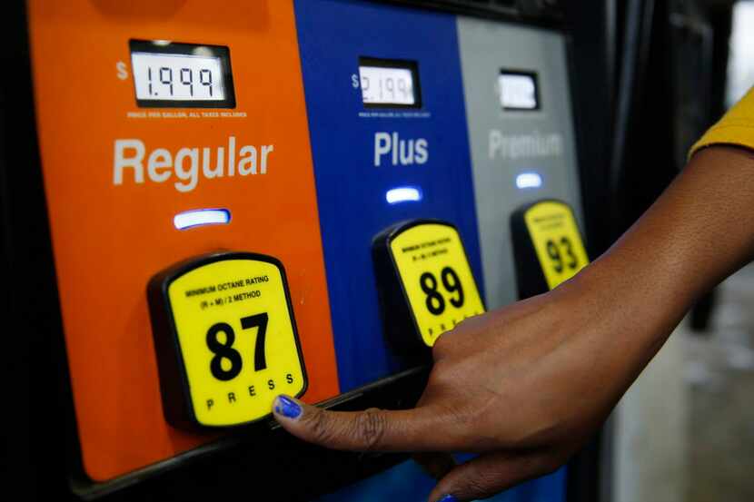  Crystal Goree, of Dallas, begins to pump $1.99 unleaded gas into her vehicle while a gallon...