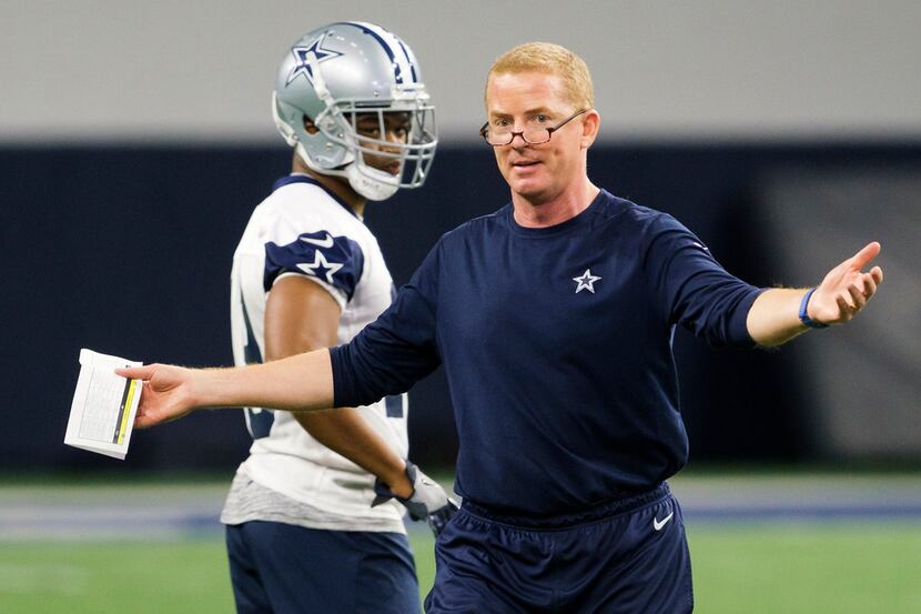 Dallas Cowboys head coach Jason Garrett makes a point as wide receiver Amari Cooper listens...