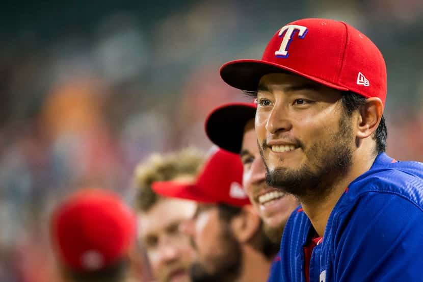 Texas Rangers pitcher Yu Darvish watches from the dugout during the eighth inning of a 9-3...