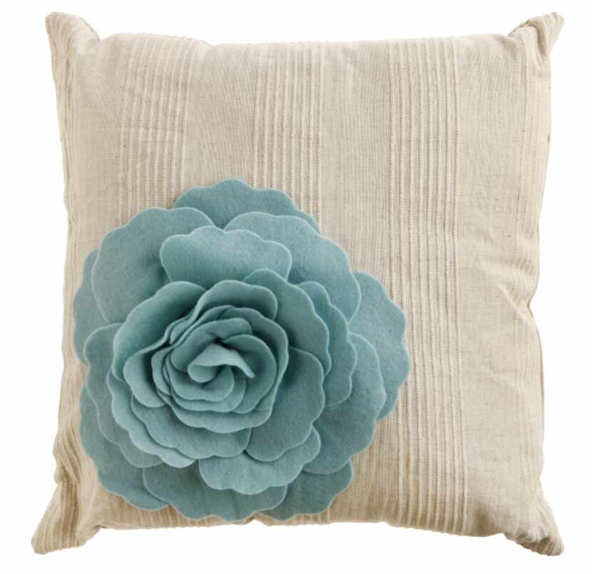 Pillows of linen and cotton, 16 inches square, are embellished with felt floral blooms....