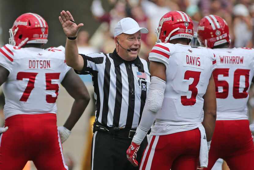 Referee Matt Austin explains the situation to the players after the stadium game clock went...