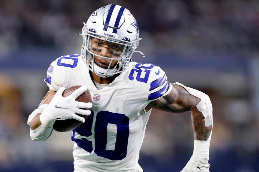 Dallas Cowboys running back Tony Pollard (20) looks toward the end zone after a first half...