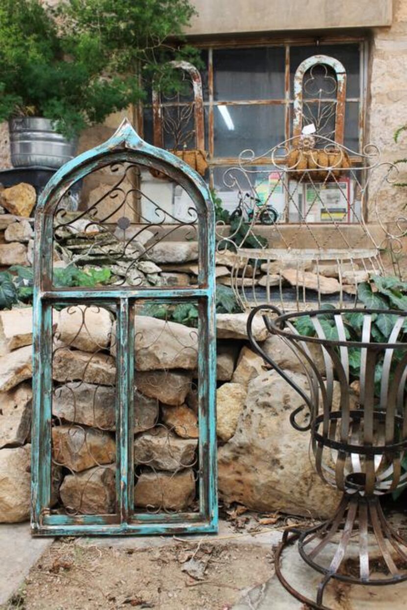 
Salvaged decorative elements in a historic stone building provide the backdrop for plants...