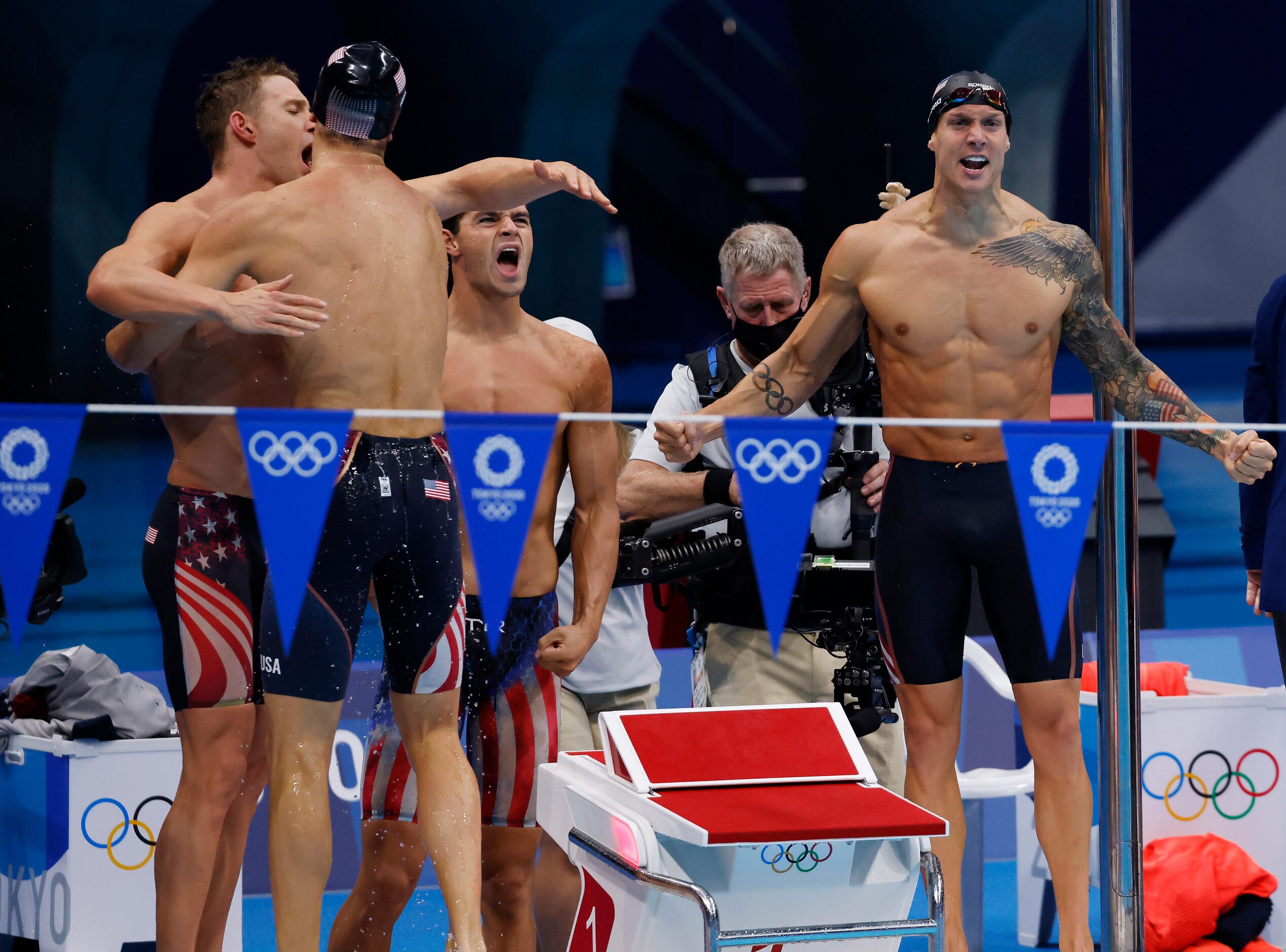 USA’s Ryan Murphy hugs Zach Apple as Michael Andrew and Caeleb Dressel celebrate setting a...