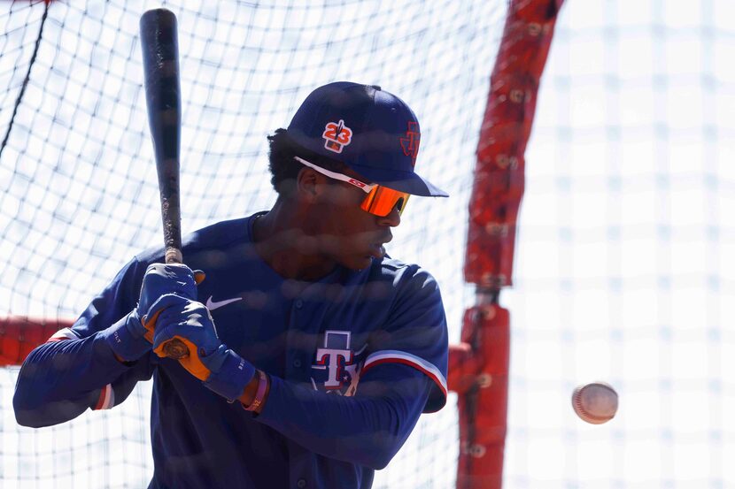 Texas Rangers minor league infielder Sebastian Walcott takes part in a batting practice...