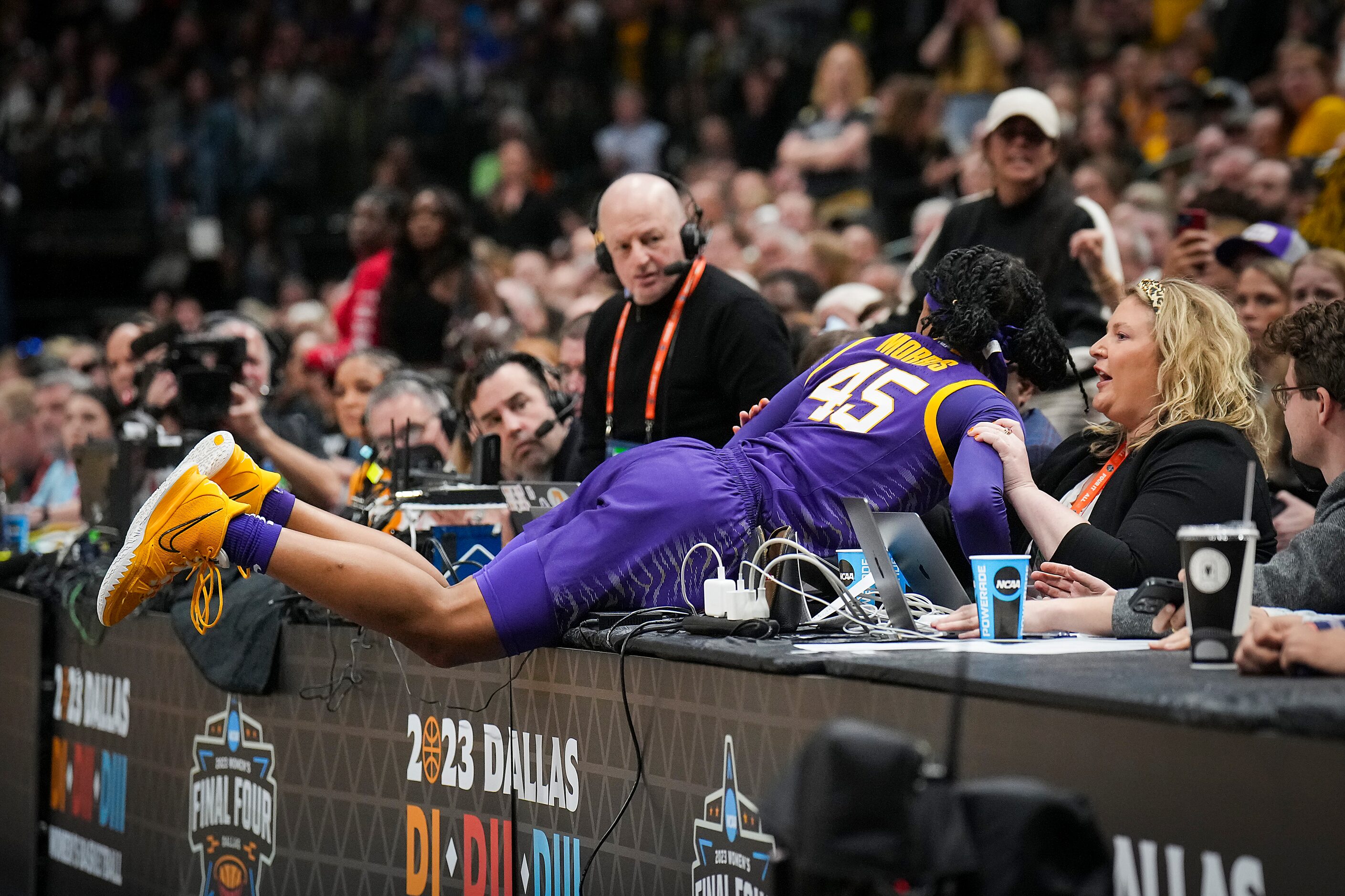 LSU guard Alexis Morris (45) dives into the press table after trying to save a ball from...