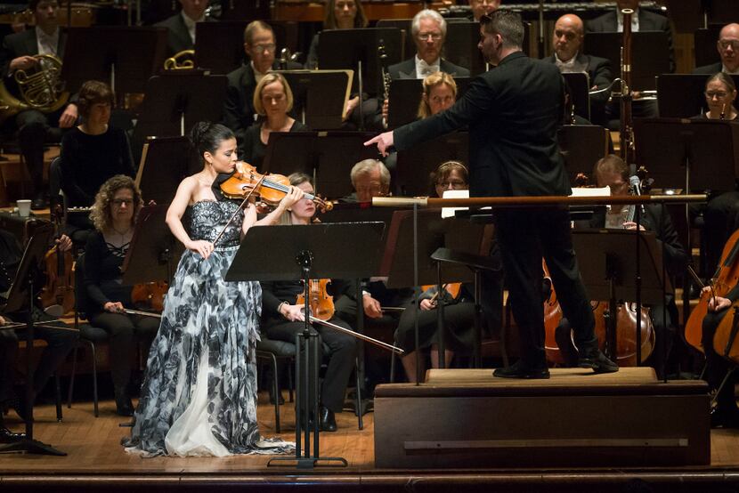 Guest conductor Matthias Pintscher points to violin soloist Karen Gomyo as she performs with...