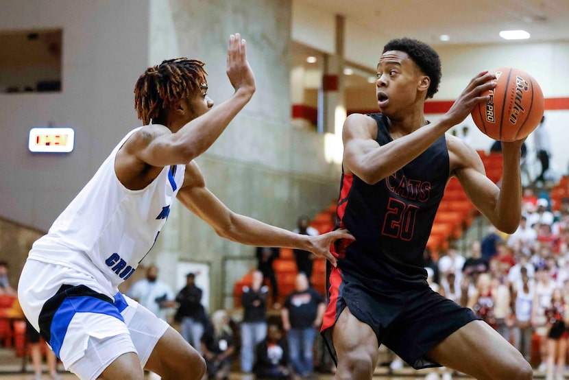 North Crowley High wing KD Davis (left) defends as  Lake Highlands High guard Tre Johnson...