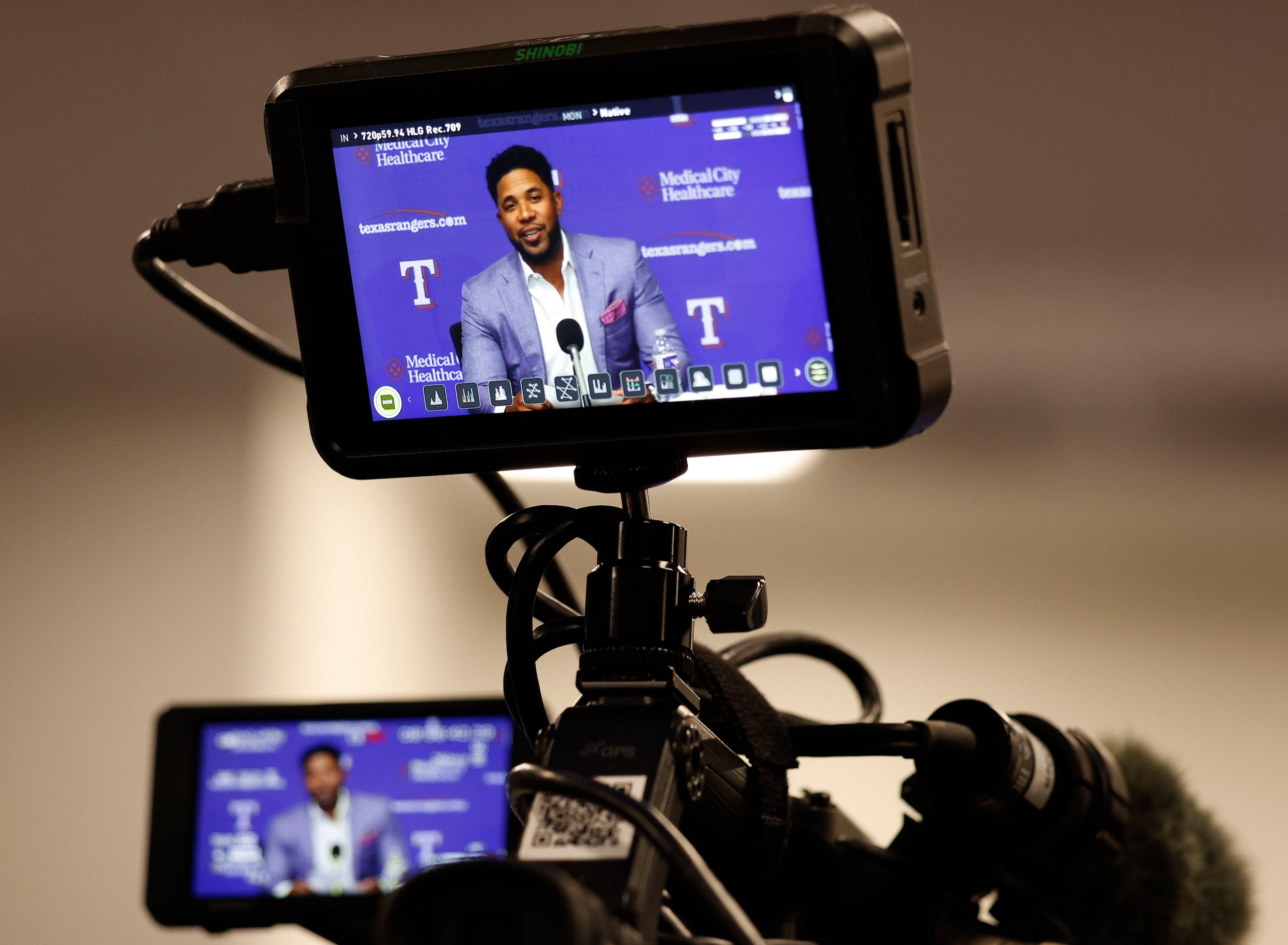 TV monitors shows Elvis Andrus speaking during a news conference to announce his official...