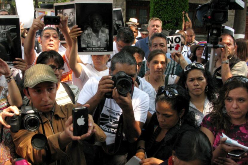 Journalists protest during a demonstration condemning the alleged murder of fellow...