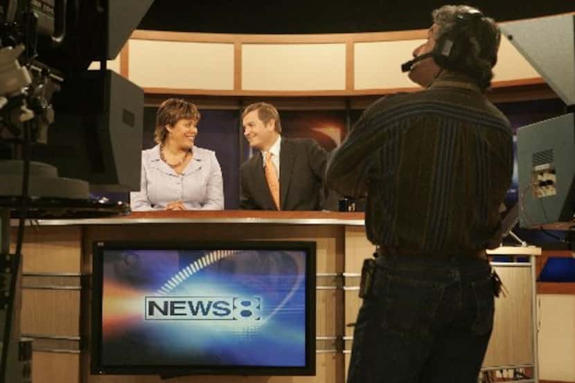WFAA-TV channel 8 Daybreak floor director Gil Gonzales (foreground) watches a monitor as...