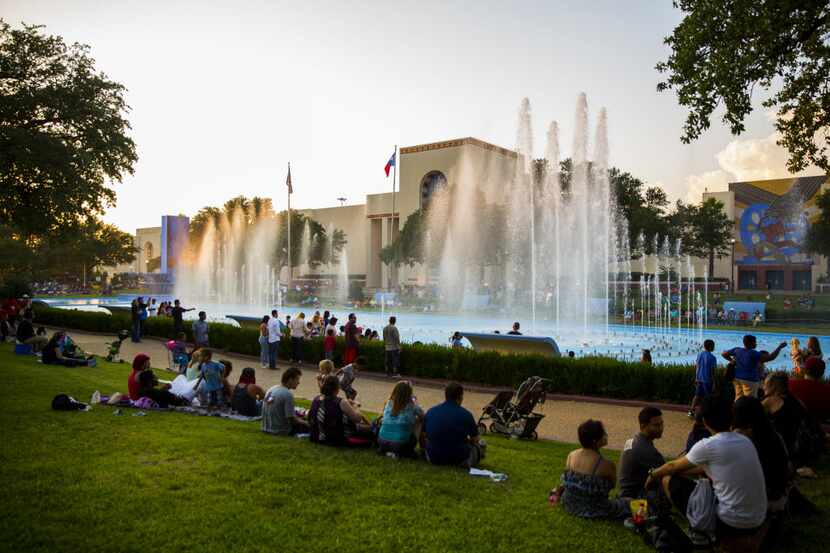 Families relax on the Esplanade while celebrating Independence Day at Fair Park in Dallas on...