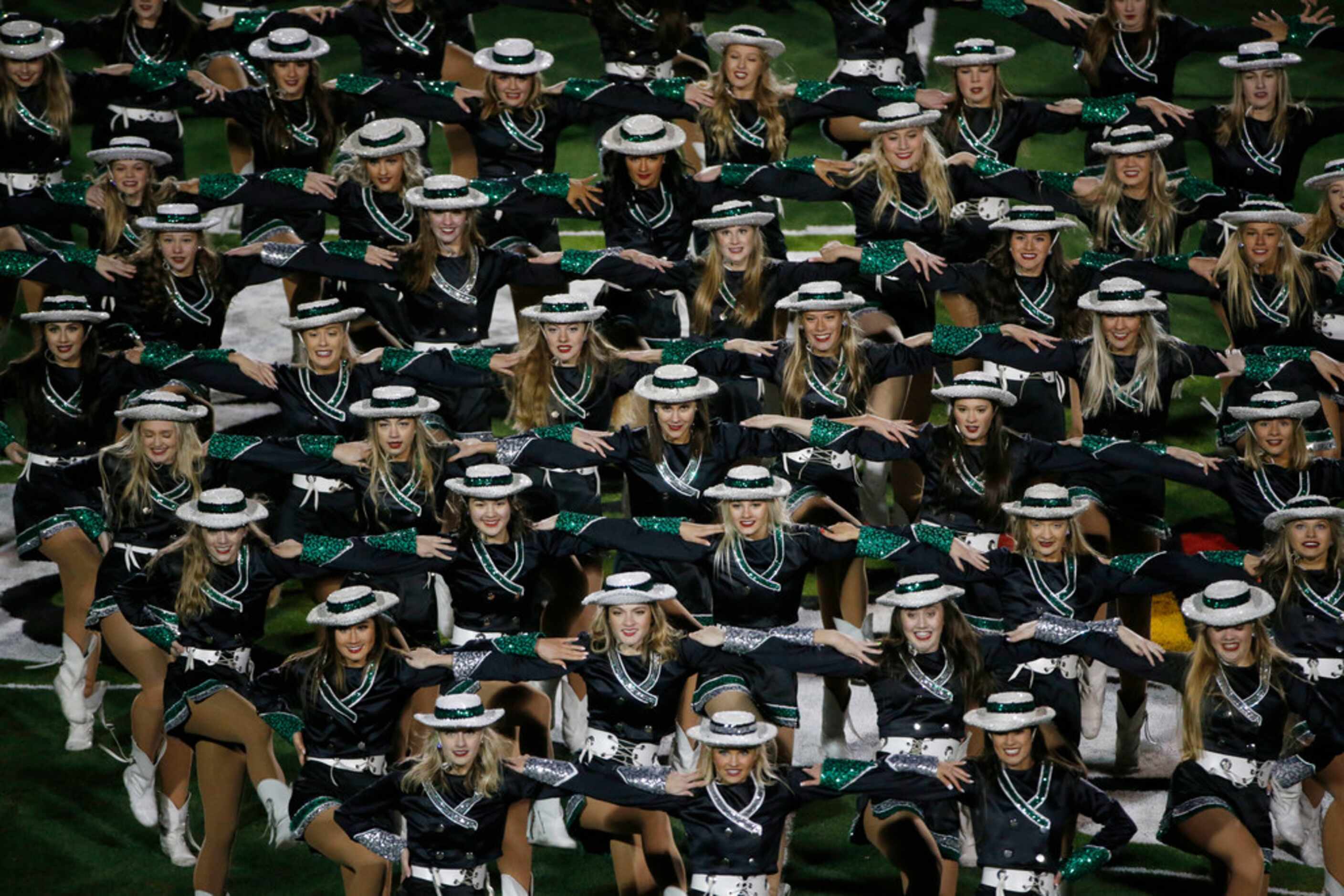 The Southlake Carroll Emerald Belles drill team performs at half time of their high school...