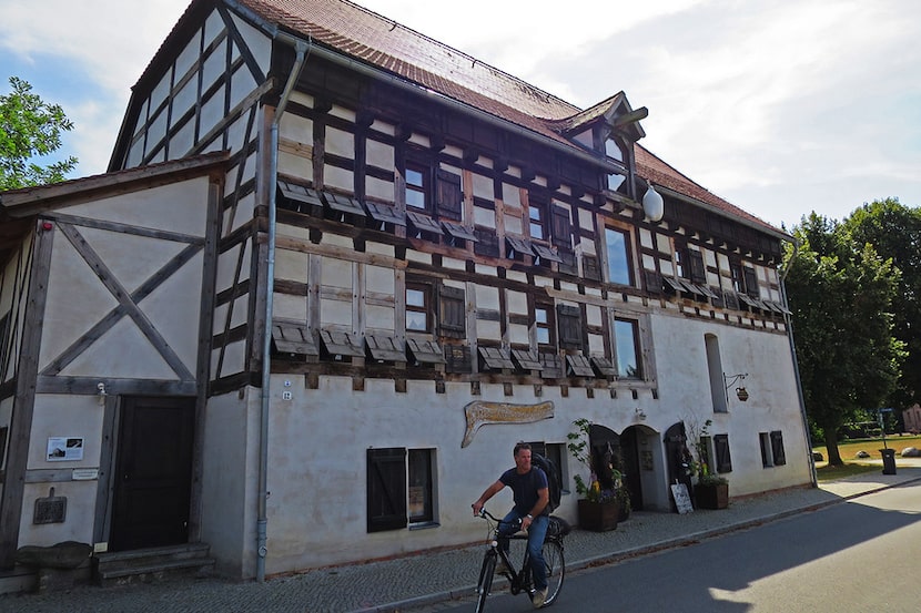 Biking past a traditional farmhouse in the Spreewald. 