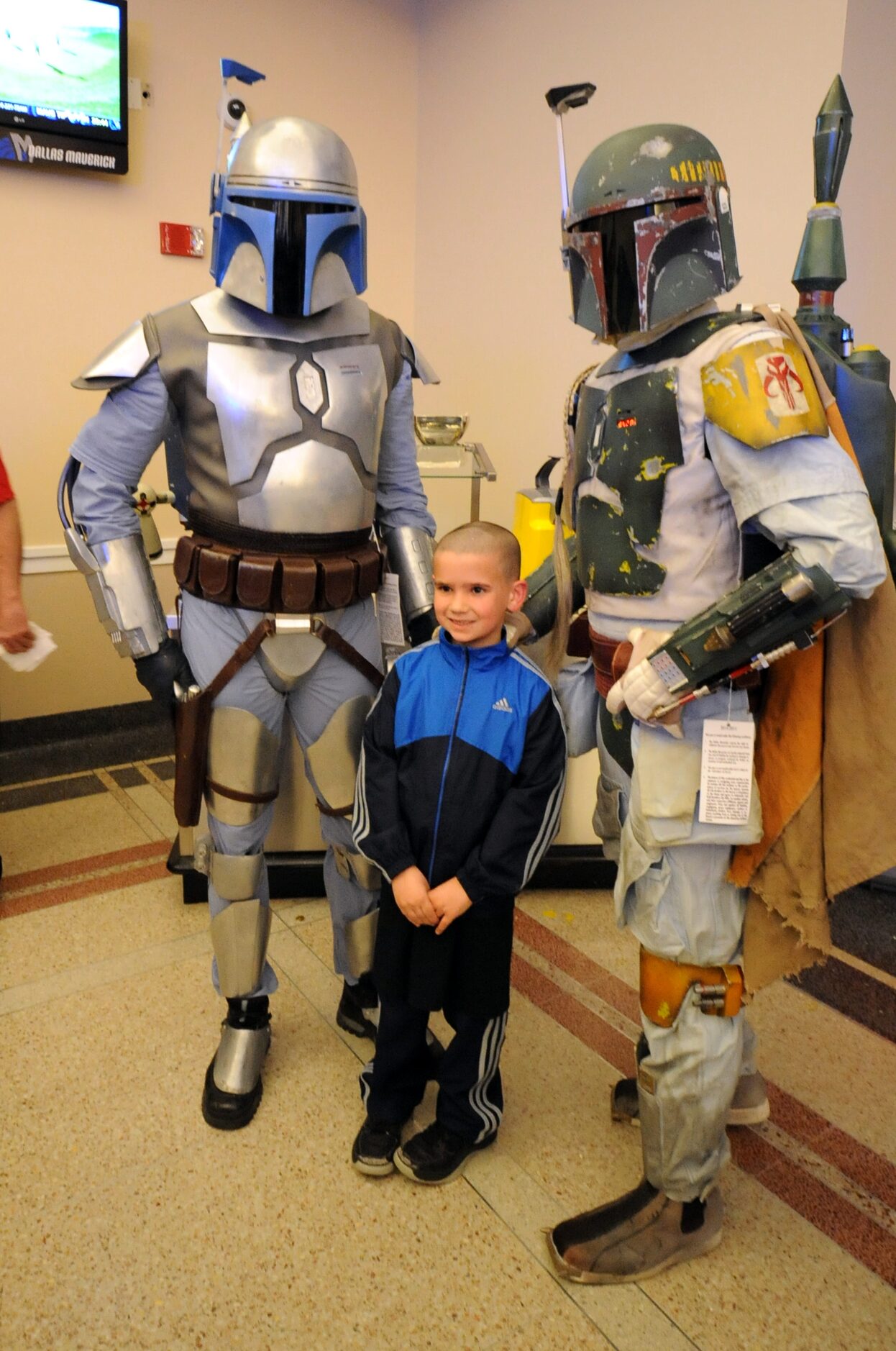 A fan meets Jango Fett and Boba Fett at Star Wars night at the Dallas Mavericks basketball...