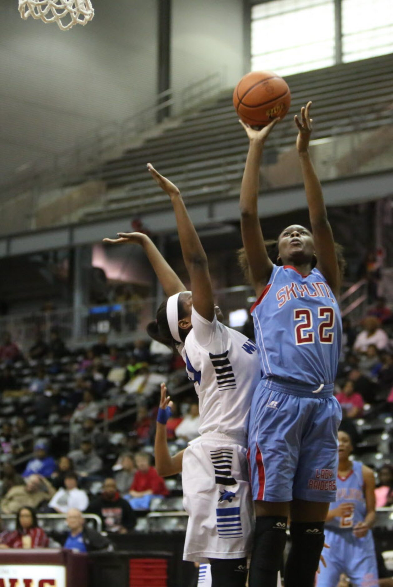 Skyline center Jamesia Amand (right) goes up for a layup during the first half of the region...