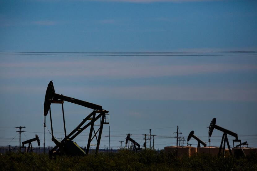 Oil pumpjacks line the horizon just west of Penwell, Texas.