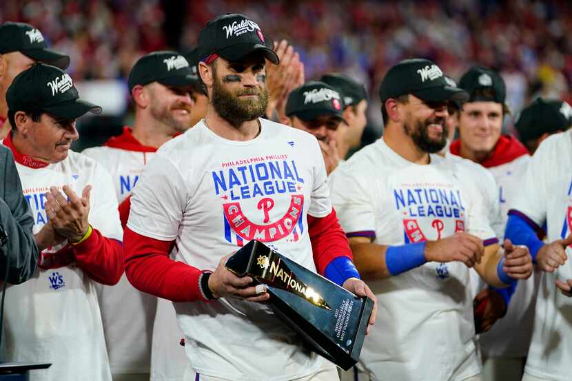 Philadelphia Phillies designated hitter Bryce Harper celebrates with the trophy after...