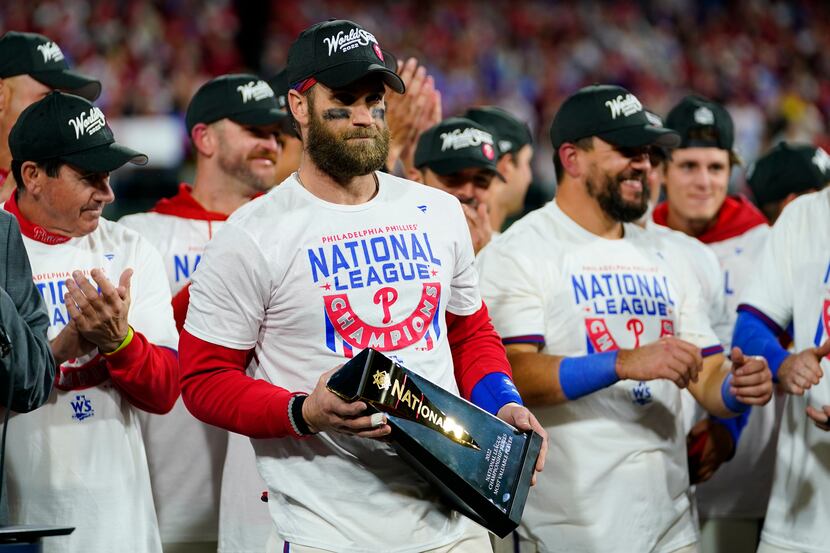 Philadelphia Phillies designated hitter Bryce Harper celebrates with the trophy after...