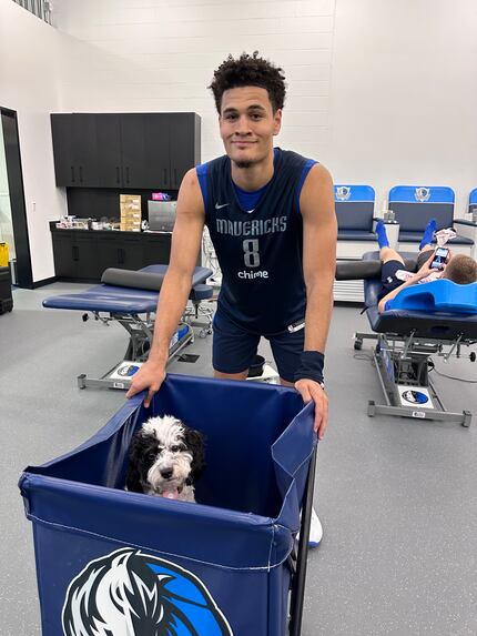 Josh Green poses for a picture with Bailey, the Dallas Mavericks' emotional support dog.